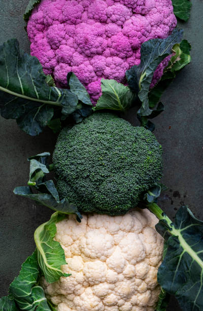 istock White and lilac cauliflower, broccoli cabbage from farm market on old rustic green table 1918281571