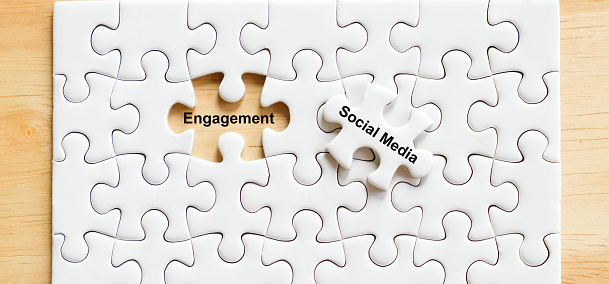 Social media and engagement word on jigsaw puzzle background, Digital marketing concept