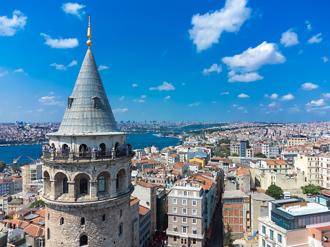 Istanbul, Turkey - September 1 2023: Close-up view of the Galata Tower with tourists, one of the historical symbols of Istanbul. View of Galata Tower, Istanbul on a sunny bright day.