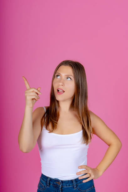 istock Young Woman Having a Bright Idea on Pink Background 1918393688