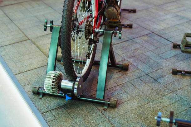 Unrecognizable athlete cycling on stationary bike in a health club.