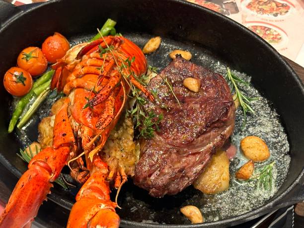 grilled lobster and sirloin steak - lobster steak lobster tail main course foto e immagini stock