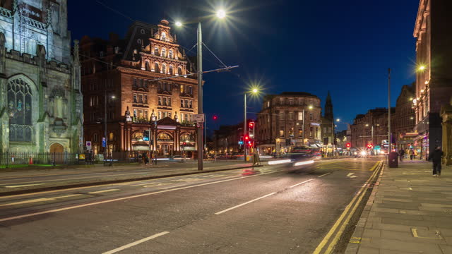 Road traffic at Princes street and junction in City of Edinburgh, Scotland at night - 4k Time-lapse