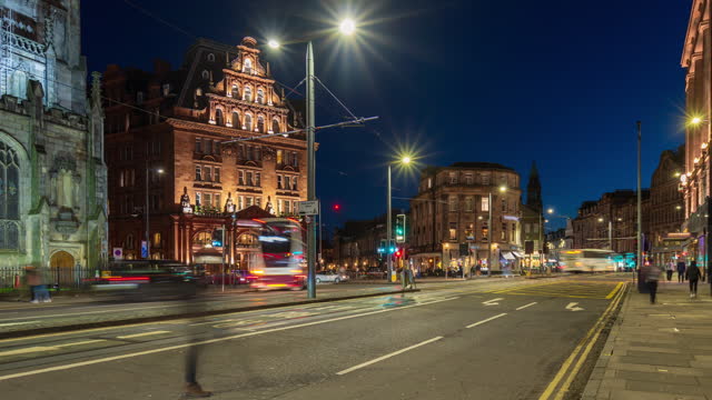 Road traffic at Princes street and junction in City of Edinburgh, Scotland at night - 4k Time-lapse (tilt up)