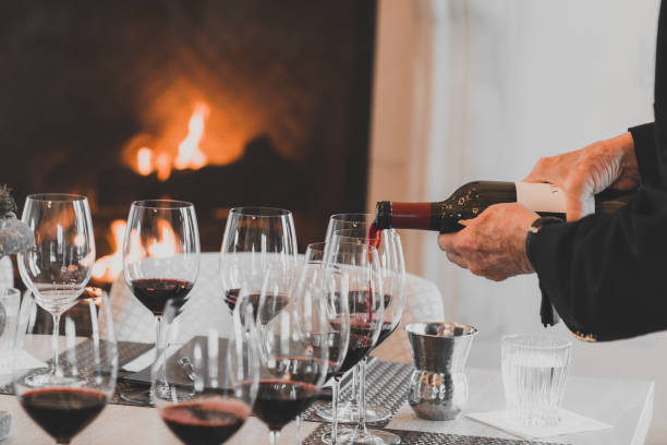 istock Red wine poured into glasses against a fireplace backdrop 1918513209