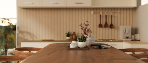 Close-up image, A beautiful hardwood dining table in a modern, Scandinavian kitchen.