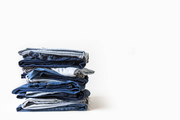 istock Stack of various shades of blue jeans on white background 1918569290