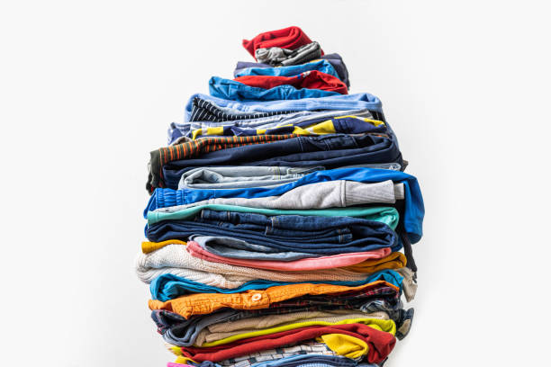 istock A very tall stack of folded colored clothes for charity, washing, ironing and sorting. 1918573240