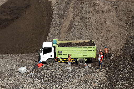 A truck is loaded with volcanic stones at a quarry in Indonesia. Bali, Indonesia - 03.08.2018
