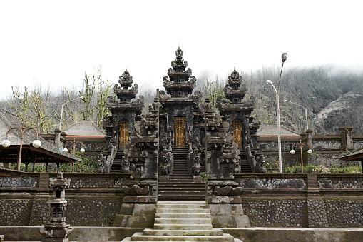 The large sacred traditional temple of Pura Pasar Agung Sebudi on the mountain after the ash eruption at Mount Agung on the popular tourist island of Bali