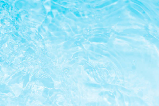 istock Bluewater waves on the surface ripples blurred. Defocus blurred transparent blue colored clear calm water surface texture with splash and bubbles. Water waves with shining pattern texture background. 1918666224