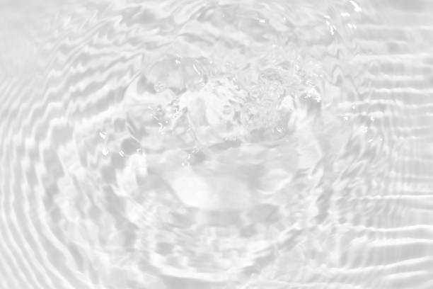 istock White water with ripples on the surface. Defocus blurred transparent white colored clear calm water surface texture with splashes and bubbles. Water waves with shining pattern texture background. 1918666227