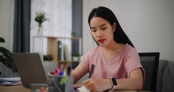 istock Young woman using laptop working at home. 1918670031