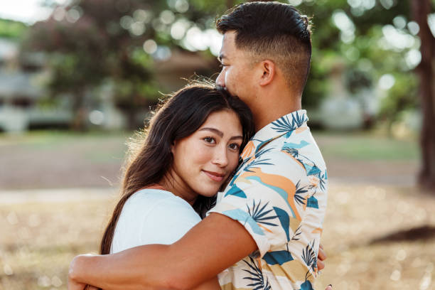 Affectionate Pacific Islander couple at the park