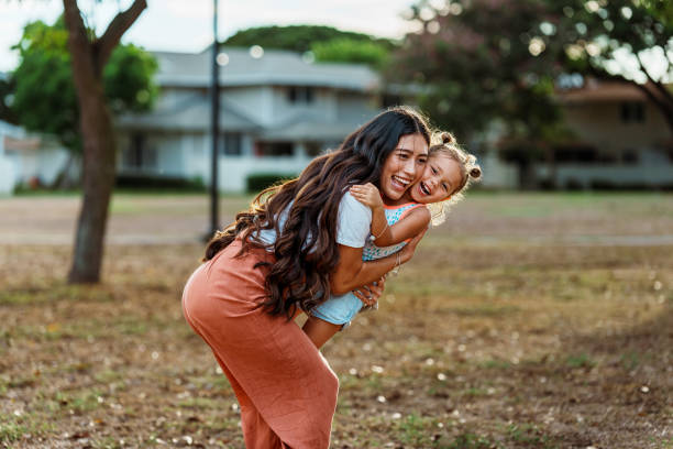 istock Loving mom and daughter playing together outside 1918697227