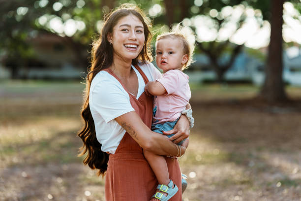 mamá amorosa y bebé de un año disfrutando del tiempo al aire libre - monoparental fotografías e imágenes de stock