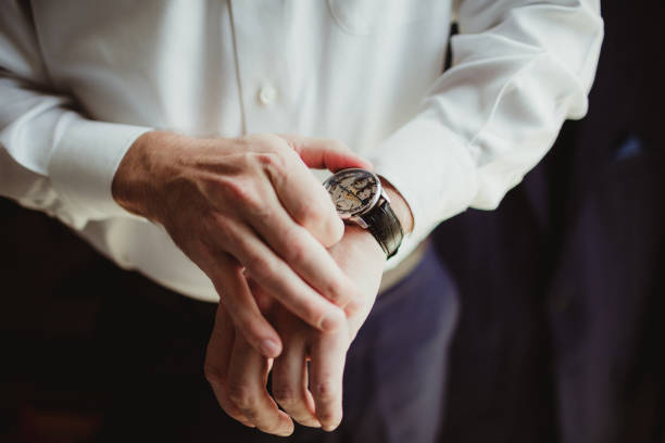 istock Man putting watch on 1918701440