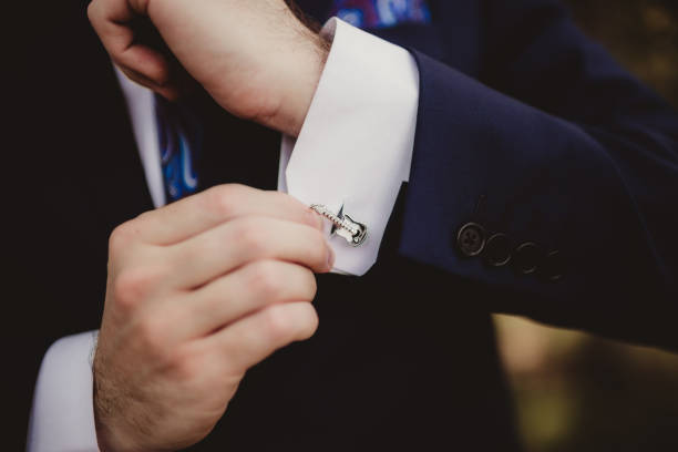 Groom getting dressed on wedding day
