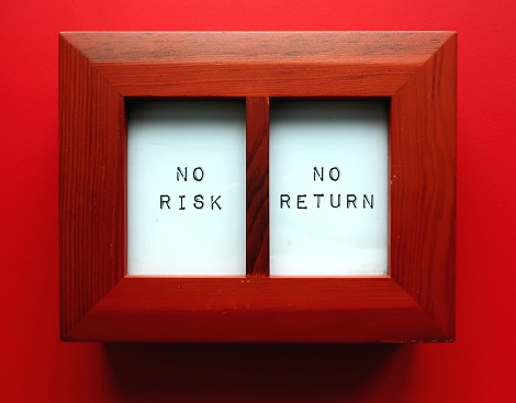 Photo frame on red background with text written NO RISK NO RETURN, investment principle - investor is willing to take risks in order to get some financial gains