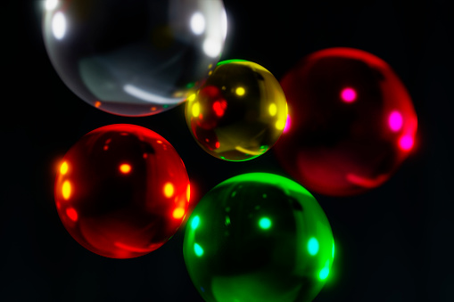 Bright colored shiny balls as an abstraction on a black background.