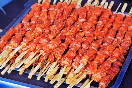 Grilled chicken string in a restaurant, closeup of photo