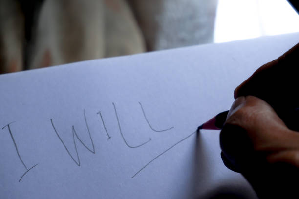 istock handwritten word I WILL with pencil on white paper 1918811926