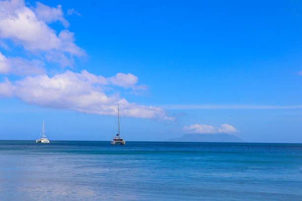 Two catamarans in the bay of Beau Vallon beach