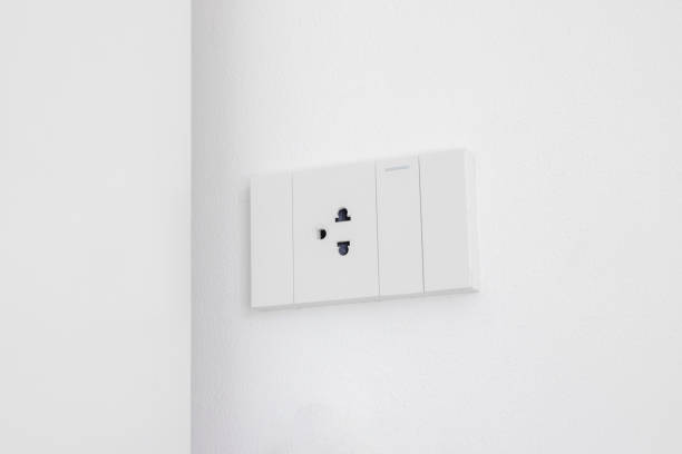 istock Modern white electrical sockets and light switches on white wall. Plug studio apartment power supply. Light switch. Power outlet. Concept of technology, connection, power saving, energy saving. 1918833783