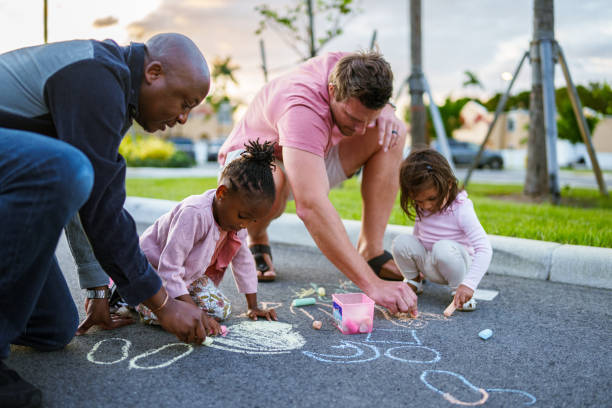 istock Dads coloring with sidewalk chalk outside with their kids 1918838565