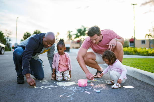 istock Dads coloring with sidewalk chalk outside with their kids 1918838579