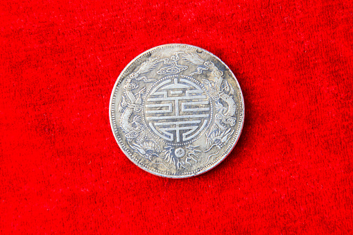 TAGNSHAN CITY - AUGUST 31: Labeled Guangxu yuan treasure ping heavy one two made in guangdong province words on the silver dollar, in an exhibition hall, on august 31, 2013, tangshan city, hebei province, China.