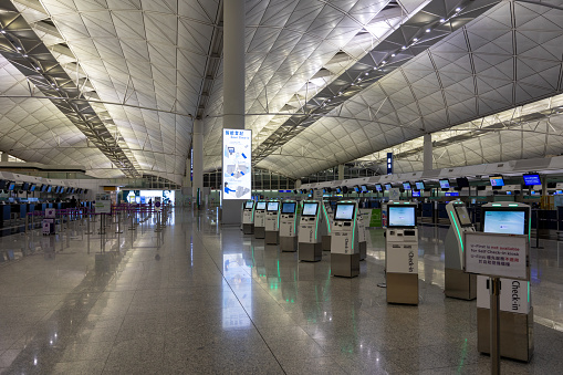 Hong Kong - December 19, 2023 : Airport check-in counters at the Hong Kong International Airport.