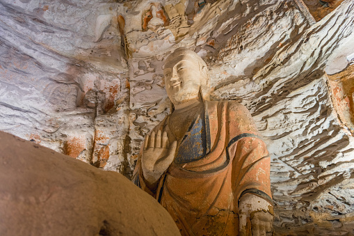 Inside the Yungang Grottoes. World cultural heritage. One of China's four most famous Buddhist Caves Art Treasure Houses, is located Datong, Shanxi Province. It is cave 20. Buddha is 13.7 metres high.