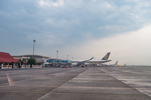landscape of Terminal 2 of Juanda International Airport which is equipped with a modern boarding bridge with several planes parked on the apron, Indonesia, 6 January 2024
