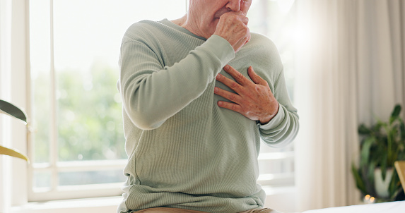 Coughing, sick and a person feeling chest for pain, heart attack or health problem at home. Healthcare, covid and a man with a cold, flu or virus of the lungs, infection or symptom of a disease