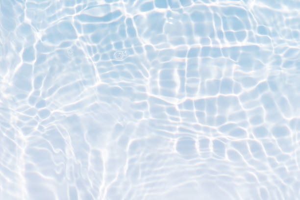 istock Bluewater waves on the surface ripples blurred. Defocus blurred transparent blue colored clear calm water surface texture with splash and bubbles. Water waves with shining pattern texture background. 1918910754