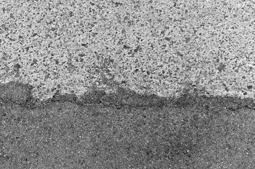 Dirty old asphalt road texture background.  Rough and grunge surface background.