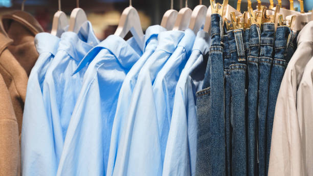 istock Clothes and jeans on hangers in a store 1918945948