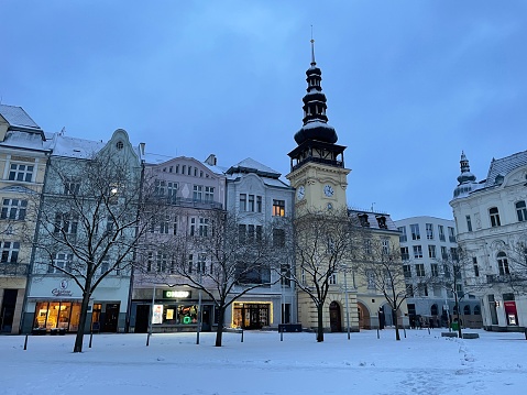 Ostrava, Czech Republic - January 07, 2024: Masaryk Square, the central square of Ostrava, overlooking the Old Town Hall on a snowy cold winter evening