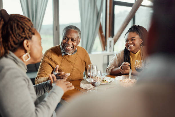 istock Happy black family talking during a meal at dining table. 1918954954