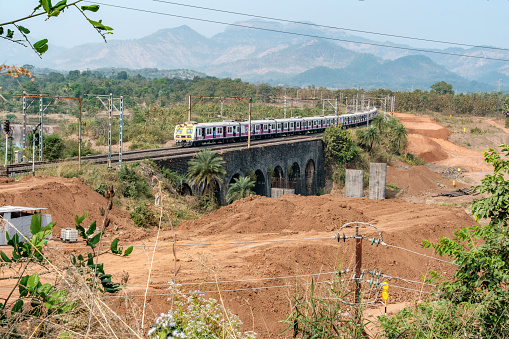 Pune, India - January 2024: A local suburban commuter train in the countryside  near Pune India.