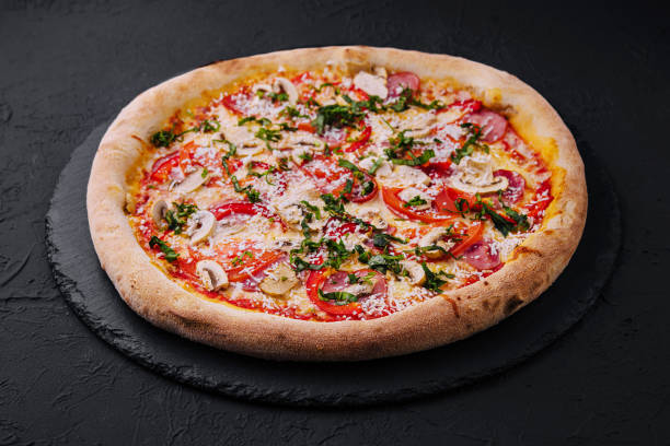 istock Delicious freshly baked pizzas on black plate 1918961874