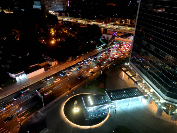 High angle view of the street traffic jam by Shanghai Wheelock Square at night, a skyscraper located in Puxi, Shanghai, China. It is the sixth-tallest building in Shanghai at 270 mt height.