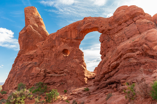Tourists Hiking to the South and North Window Arch in Arches National Park in Utah. Scenic Desert Landscape in Moab, United States