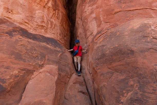 istock Boy Climbing Rocks in Arches National Park, Utah 1918972571
