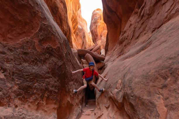 istock Boy Climbing Rocks in Arches National Park, Utah 1918972573