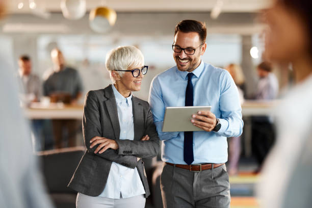 istock Happy business colleagues reading an e-mail on touchpad in the office. 1918985096