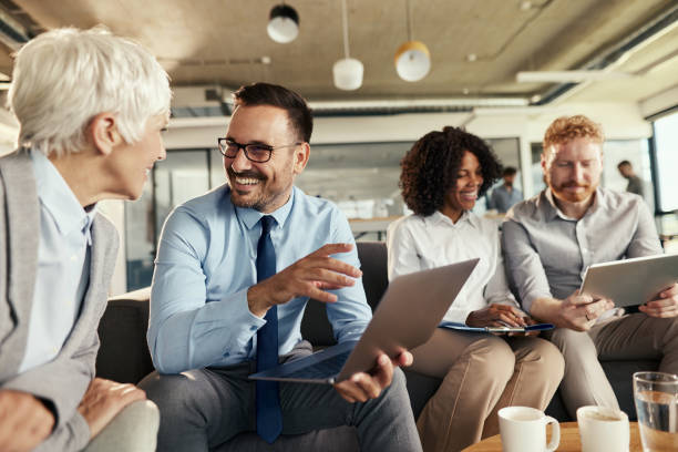 istock Happy business colleagues using wireless technology at casual office. 1918987269