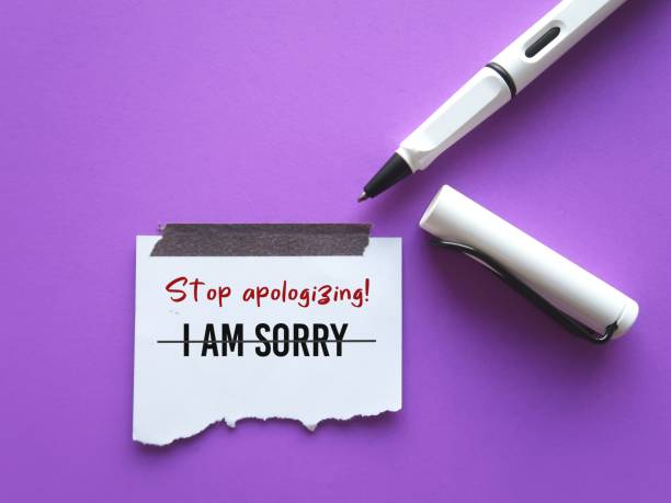 istock On purple background, pen writes on stick note I AM SORRY crossed off to Stop Apologizing, concept of stop being low self-respect by saying sorry too often every little thing that goes wrong 1918995942