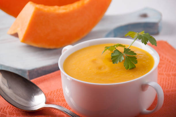 Pumpkin cream soup in a white plate stock photo